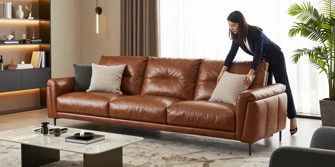 Modisches Wohnzimmer mit einem Baxter Ledersofa Preis, luxuriöser Dekoration und Designer-Kissenarrangements.